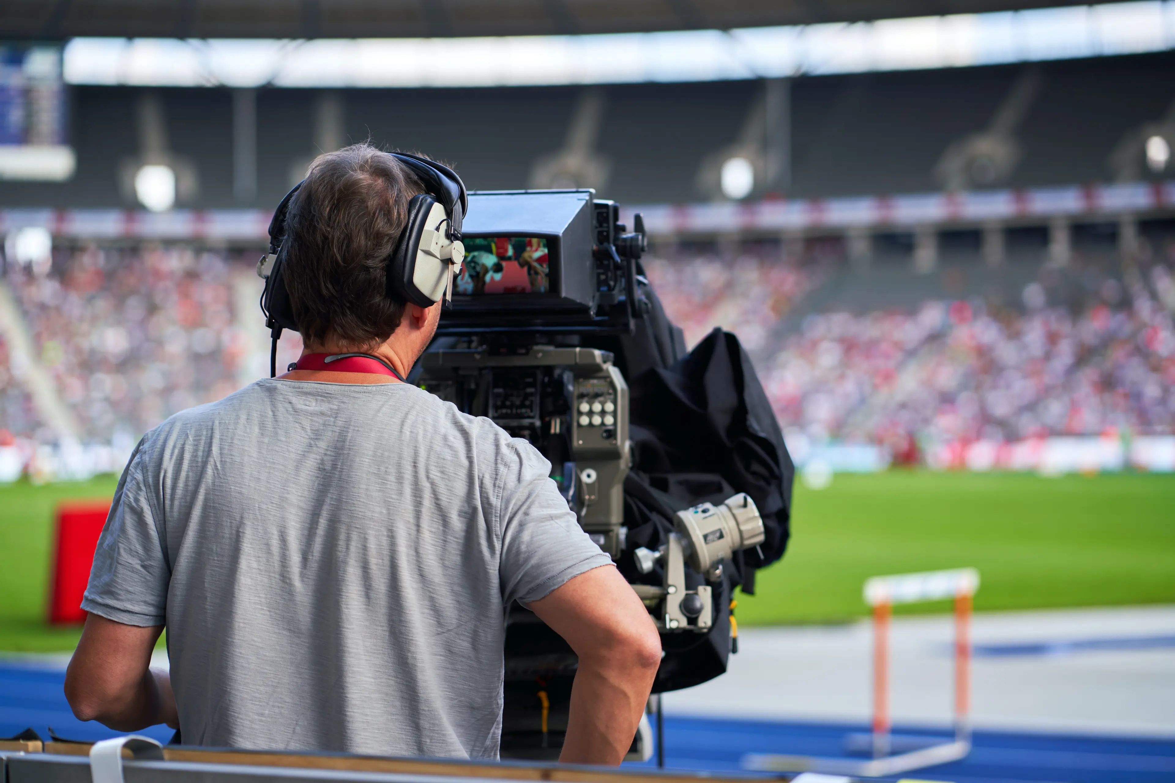 A cameraman filming a sports event